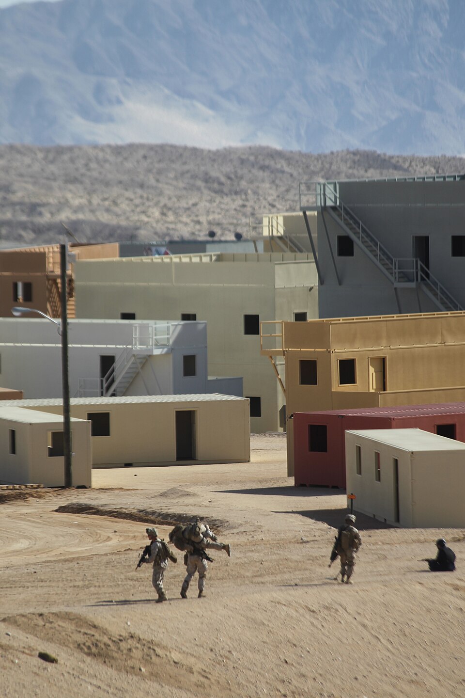 Marines carrying a simulated casualty during urban training